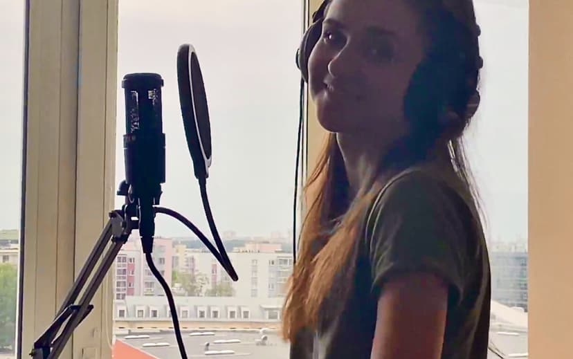 Iveta smiling near microphone